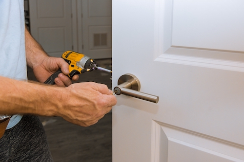 Installation locked interior door woodworker hands install lock